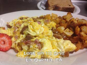 Product: Meat Lovers Omelet (shown as a scramble) - Lost on 111 Grill in La Quinta, CA American Restaurants