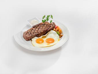 Product: Thick grilled NY strip steak | 2 eggs your way | Breakfast potatoes - M.a.c. 24/7 in Waikiki - Honolulu, HI American Restaurants