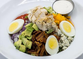 Product: CHOPPED COBB SALAD Grilled chicken, tomatoes, red onions, bacon, cucumber, Maytag bleu, cheddar, sliced egg, avocado, mixed greens, bleu cheese dressing - Mill Creek Tavern in Bayville, NY American Restaurants