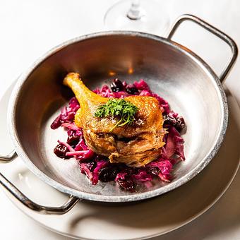 Product: Duck Confit ~ red cabbage & bacon, dried cherries, black pepper brandy - Mon Ami Gabi in Lincoln Park West - Chicago, IL French Restaurants