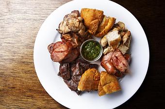 Product: Grilled skirt steak, chorizo, chicken, empanadas, chimichurri sauce - Novecento Brickell in Miami, FL Steak House Restaurants