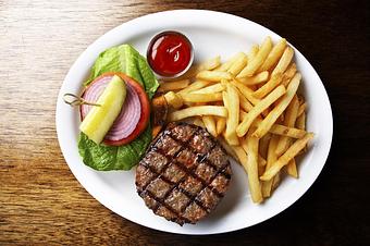 Product: Grilled burger, lettuce, tomato, pickle, fries - Novecento Brickell in Miami, FL Steak House Restaurants