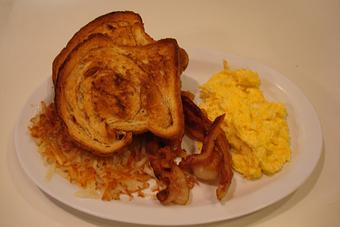 Product: Two eggs any style, bacon or sausage, our homemade cinnamon toast and Hash browns. - Nutshell Eatery & Bakery in Granbury, TX American Restaurants