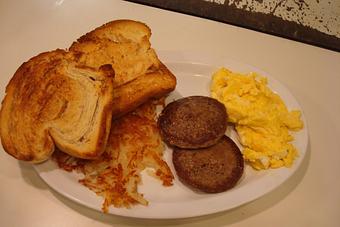 Product: two eggs any style, bacon or sausage, our homemade cinnamon toast and hash browns - Nutshell Eatery & Bakery in Granbury, TX American Restaurants