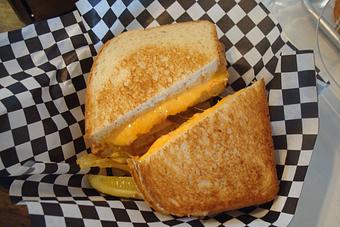 Product: Grilled Cheese or Grilled Pimento Cheese, served with chips and a pickle. - Nutshell Eatery & Bakery in Granbury, TX American Restaurants