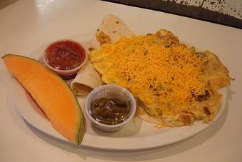 Product: Two Eggs, Sausage, Onion, and Hash Browns topped with Cheese and Cilantro on a Flour Tortilla. - Nutshell Eatery & Bakery in Granbury, TX American Restaurants