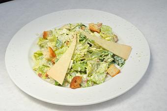 Product: Caesar salad topped with homemade croutons, parmesan cheese and crispy bacon - Pasta D'arte Trattoria Italiana in Chicago, IL Italian Restaurants