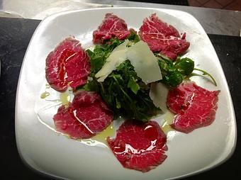 Product: Thinly sliced beef, extra virgin olive oil, arugala & grana padano - Pazzo Pomodoro in Vienna, VA Italian Restaurants