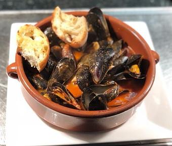 Product: Prince Edward Island mussels steamed in white wine with chopped tomatoes & garlic rubbed crostini. House specialty! - Pazzo Pomodoro in Vienna, VA Italian Restaurants