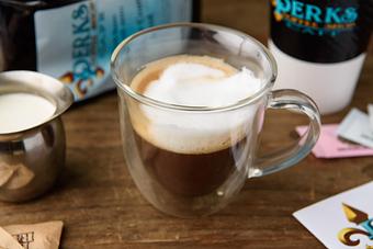 Product: shot of espresso with the froth of steamed milk (dry).  Add a little of the steamed milk (wet). - Perks Coffee Shop & Cafe in Gulfport, MS Bakeries