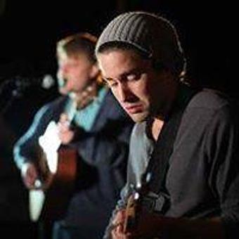 Product: Jay Killman and his guitar at the bistro. - Ports Of Call in Downtown Historic Southport - Southport, NC Bars & Grills