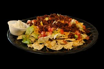 Product: Taco Salad: Tortilla Chips, lettuce, cheddar cheese, tomatoes, & taco meat... served with sour cream and taco sauce. - Powerhouse Pizza in Camden, OH American Restaurants