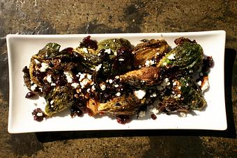 Product: Brussel sprouts fried golden and tossed with cranberry, chili flake and finished with goat cheese and balsamic reduction. - PUBlic 74 in San Juan Capistrano, CA American Restaurants