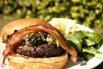 Product: Char grilled 10oz of american kobe beef on brioche bun topped with smoked pork belly, leeks, kale, wilted spinach and smoked cheddar. Fries too! - PUBlic 74 in San Juan Capistrano, CA American Restaurants