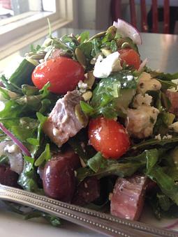 Product: Made to order with organic greens, flank steak, tomato, cucumber, shaved red onion, kalamata olives, feta and toasted pumpkin seeds tossed with red wine vinaigrette. - Purple Onion Cafe in Los Gatos / Campbell border - Los Gatos, CA American Restaurants