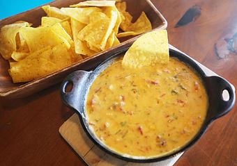 Product: A bubbling fondue of cheese and seasoned beef. Served with chile-spiked corn tortilla chips. - Que Pasa Cantina in Rapid City, SD Mexican Restaurants