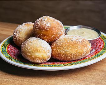 Product: five sweet mini brioche donuts fried to order and tossed in vanilla sugar. served with miso caramel sauce - Ramen San in Chicago, IL Japanese Restaurants