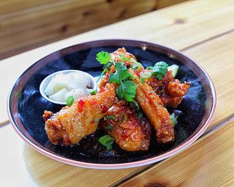 Product: five crispy chicken wings tossed in a housemade sweet chili sauce. served with pickled japanese daikon radish and lime - Ramen San in Chicago, IL Japanese Restaurants