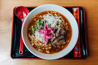 Product: our play on the traditional mexican dish. slow-braised adobo beef, topped with cilantro, pickled red onion, radish slices, shredded green cabbage, and a squeeze of lime for brightness - Ramen San in Chicago, IL Japanese Restaurants