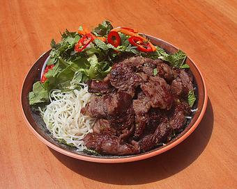 Product: marinated beef is seared and served over fresh greens with carrot, rice noodles, thai herbs and a thai vinaigrette - RAMEN-SAN Whisky Bar in Fulton Market - Chicago, IL Japanese Restaurants