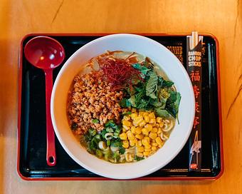 Product: featuring our classic chicken broth with a green curry and coconut miso, topped with a thai chicken larb, buttered corn, green onions, thai basil, cilantro, and mint with a squeeze of lime - RAMEN-SAN Whisky Bar in Fulton Market - Chicago, IL Japanese Restaurants