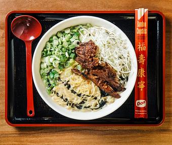 Product: one of our most popular specials, this bowl features our double tonkotsu broth, topped with crispy carnitas pork shoulder, finished with shredded cabbage, green onions, and a savory burnt garlic oil - RAMEN-SAN Whisky Bar in Fulton Market - Chicago, IL Japanese Restaurants