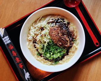 Product: one of our oldest and most popular specials, this bowl features a fortified version of our 10 hour tonkotsu broth, topped with crispy pork shoulder, shredded cabbage, green onions, and a savory burnt garlic oil - RAMEN-SAN Whisky Bar in Fulton Market - Chicago, IL Japanese Restaurants