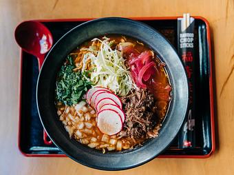 Product: our play on the traditional mexican dish. slow-braised adobo beef served with tokyo wavy noodles and a savory beef and chicken broth, topped with cilantro, pickled red onion, radish slices, shredded green cabbage, and a squeeze of lime for brightness. - RAMEN-SAN Whisky Bar in Fulton Market - Chicago, IL Japanese Restaurants