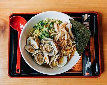Product: featuring our classic chicken broth with shio salt, 10 clams sauteed with garlic and chili, topped with mushrooms, scallions, fried garlic, sesame, oregano, and a fresh squeeze of lemon - RAMEN-SAN Whisky Bar in Fulton Market - Chicago, IL Japanese Restaurants
