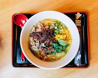 Product: featuring our classic chicken broth fortified with roasted duck seasoned with green curry miso, whole pekin ducks are cured with 5-spice and slow roasted, the ramen is then topped with fresh herbs, buttered corn, sesame chili oil, and a squeeze of lime - RAMEN-SAN Whisky Bar in Fulton Market - Chicago, IL Japanese Restaurants