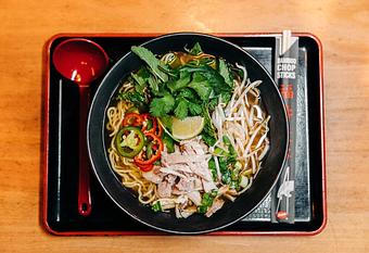 Product: featuring our classic chicken broth fortified with vietnamese spices, ramen noodles are topped with poached chicken, chiles, bean sprouts, fresh herbs, and seasoned with lime juice and fish sauce - RAMEN-SAN Whisky Bar in Fulton Market - Chicago, IL Japanese Restaurants