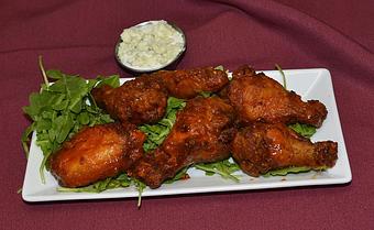 Product: Seasoned and served naked or with your choice of Frank’s Hot, Asian or house barbecue sauce - Remington's at the Montrose Bridges in Montrose, CO American Restaurants