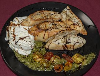 Product: Sweet cream mozzarella, baby tomatoes, balsamic reduction, grilled bread - Remington's at the Montrose Bridges in Montrose, CO American Restaurants