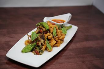 Product: puttanesca sauce | olive tapenade | shishito peppers | parmesan crema | basil - Revolution Chop House in King Of Prussia, PA Restaurants/Food & Dining
