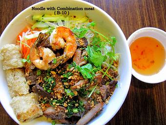 Product: Grilled pork, beef, chicken, shrimp and egg roll on vermicelli, lettuce, cucumber, and bean sprouts topped with peanut.  Served with house sauce - Saigon Wings Restaurant in Colorado Springs, CO Vietnamese Restaurants