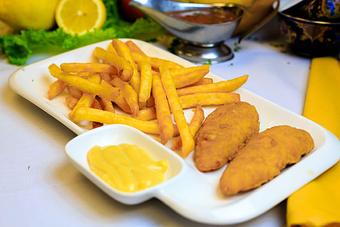 Product: Two breaded chicken tenderloins with French fries, served with a side of Honey mustard sauce - Samarkand Restaurant in Feasterville - Feasterville Trevose, PA Seafood Restaurants