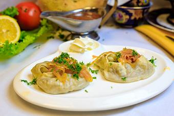 Product: Steamed Uzbek Dumplings filled with choice of lamb and beef or pumpkin.
Served with a side of sour cream and caramelized onions - Samarkand Restaurant in Feasterville - Feasterville Trevose, PA Seafood Restaurants