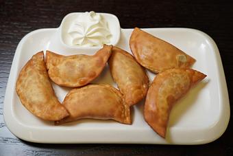 Product: Served with side of sour cream and caramelized onions. 
Available pouched or deep fired to your liking - Samarkand Restaurant in Feasterville - Feasterville Trevose, PA Seafood Restaurants