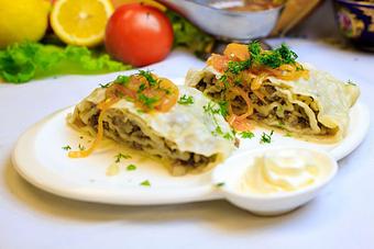 Product: Hand rolled dough filled with thinly slice beef, lamb, potatoes & onions, steamed to perfection, garnished with caramelized onion, fresh dill, and a side of sour cream - Samarkand Restaurant in Feasterville - Feasterville Trevose, PA Seafood Restaurants