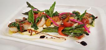 Product: Four large Maine Diver Scallops pan seared and served with side Grilled Asparagus & Parsnip puree. Garnished with Tomato Herb salad and Lemon Beurre Blanc - Samarkand Restaurant in Feasterville - Feasterville Trevose, PA Seafood Restaurants