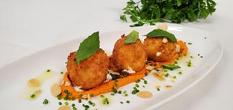 Product: Hand breaded and lightly fried herb goat cheese. Served with Romesco Sauce and toasted Almonds. - Samarkand Restaurant in Feasterville - Feasterville Trevose, PA Seafood Restaurants