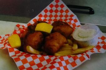 Product: Here is our famous halibut fish and chips. Enjoy it with a cool Alaskan beer today. - Sandbar & Grill in Juneau, AK American Restaurants