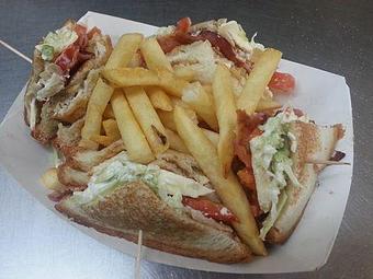 Product: Our three layer deli style club sandwich is filled with turkey, ham, Swiss and American cheese, as well as tomatoes, lettuce, and mayo. - Sandi's Drive Inn in Richfield, UT Hamburger Restaurants