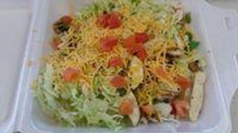 Product: Our grilled chicken salad has tender grilled chicken sauteed with mushrooms, onions, bell peppers, and is topped with tomatoes and shredded cheddar cheese. - Sandi's Drive Inn in Richfield, UT Hamburger Restaurants