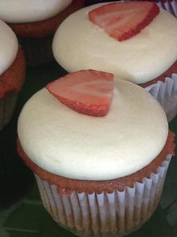Product: Strawberry Cupcake with Mango Icing topped with a fresh Strawberry - Saweet Cupcakes in San Antonio, TX Dessert Restaurants