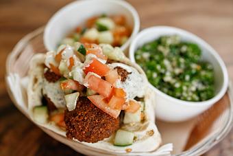 Product: a middle east classic; garbanzo beans and our house spices fried until golden brown and served with our homemade salads in our freshly baked pita. - Shaloha in Honolulu, HI Mediterranean Restaurants