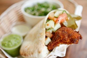 Product: a juicy chicken breast fillet (boneless & skinless), breaded and fried in our special spices, served in our pita bread with our homemade salads. - Shaloha in Honolulu, HI Mediterranean Restaurants