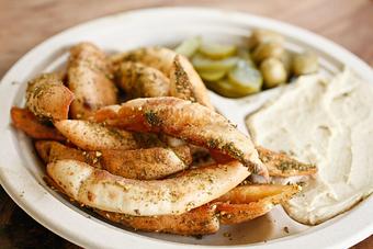 Product: shaloha's version of french fries. our pita chips are made to order, sprinkled in zaatar and served with hummus - addictive! - Shaloha in Honolulu, HI Mediterranean Restaurants
