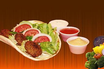 Product: Three falafel balls topped with hummus, Tzatziki sauce, shredded lettuce, pickled red cabbage,onion and tomato served in 7" greek pita. - Shondiz Cafe in Right in front of Hard Rock Cafe - Denver, CO Greek Restaurants