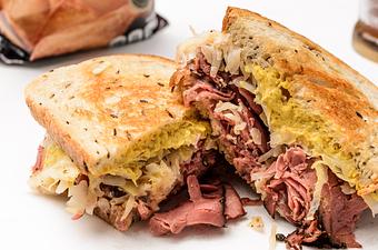 Product: Pastrami made like a Reuben (sauerkraut, spicy mustard or 1000 island, swiss cheese) - Shoreline Foods International Market & Deli in Pensacola, FL Delicatessen Restaurants